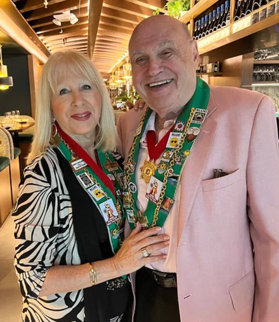 Charles and Nancy Radlauer wearing Chaîne regalia at a Miami gathering